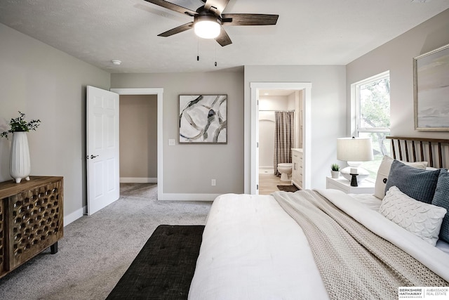 5445 S 51st St, Omaha, NE 68117 - bedroom featuring light carpet, baseboards, ensuite bath, and ceiling fan