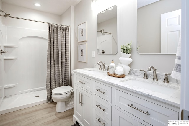 5445 S 51st St, Omaha, NE 68117 - full bath with toilet, wood finished floors, double vanity, a shower with shower curtain, and recessed lighting