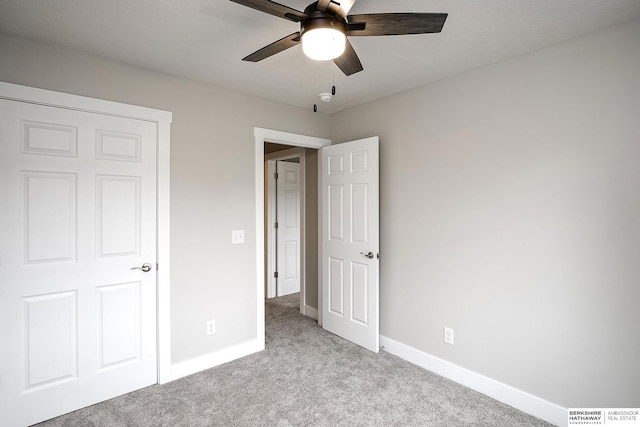 5445 S 51st St, Omaha, NE 68117 - unfurnished bedroom with light colored carpet, baseboards, and a ceiling fan