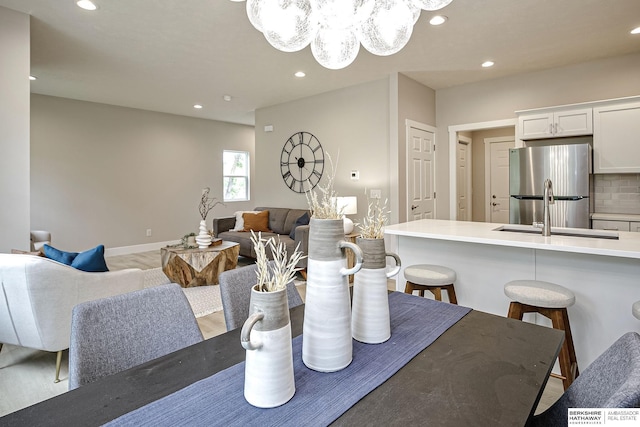 5445 S 51st St, Omaha, NE 68117 - dining area featuring recessed lighting, a chandelier, and light wood-style floors