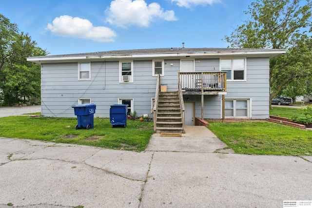 1136-1138 N D St, Fremont, NE 68025 - back of property with stairs, a deck, and a lawn