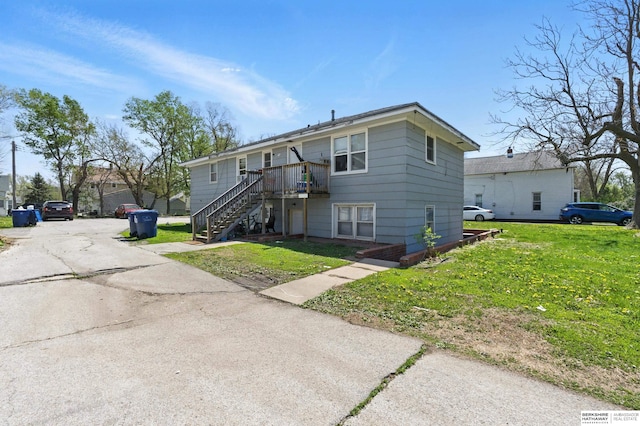 1136-1138 N D St, Fremont, NE 68025 - view of front facade with stairway, a front yard, and a wooden deck