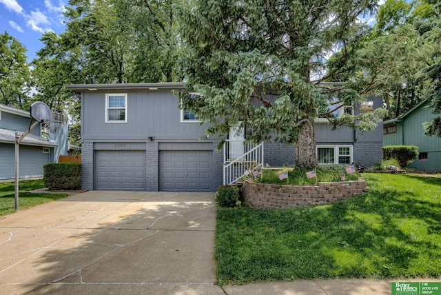 3209 Coffey Ave, Omaha, NE 68123 - view of front of home with driveway, a garage, a front yard, and brick siding