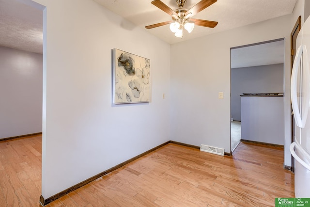 3209 Coffey Ave, Omaha, NE 68123 - unfurnished room featuring ceiling fan, light wood finished floors, and baseboards