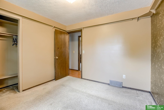 3209 Coffey Ave, Omaha, NE 68123 - unfurnished bedroom featuring carpet flooring, a textured ceiling, baseboards, and a closet