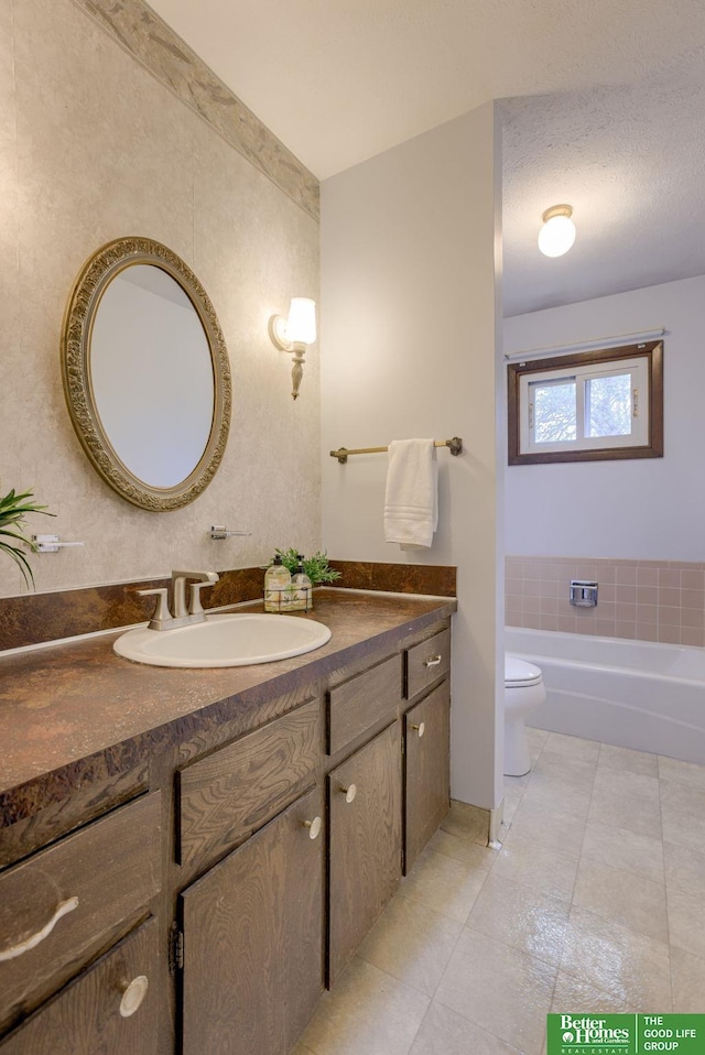 3209 Coffey Ave, Omaha, NE 68123 - full bathroom featuring vanity, toilet, tile patterned flooring, and a bathtub