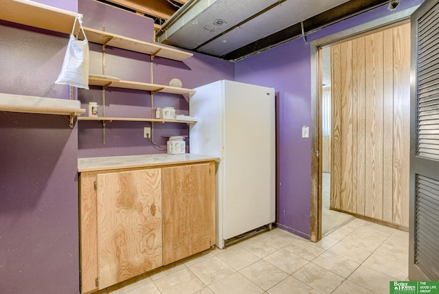 3209 Coffey Ave, Omaha, NE 68123 - basement featuring light tile patterned floors and freestanding refrigerator