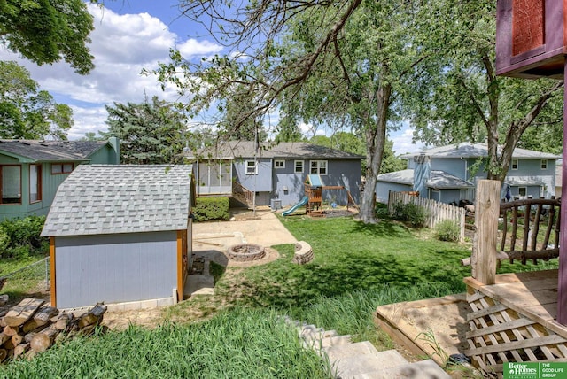 3209 Coffey Ave, Omaha, NE 68123 - view of yard featuring a fire pit, a playground, and a residential view