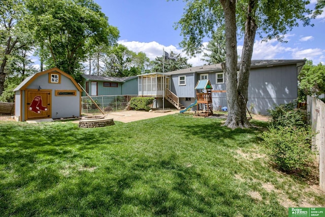 3209 Coffey Ave, Omaha, NE 68123 - view of yard with a sunroom, an outdoor fire pit, stairway, and a patio area