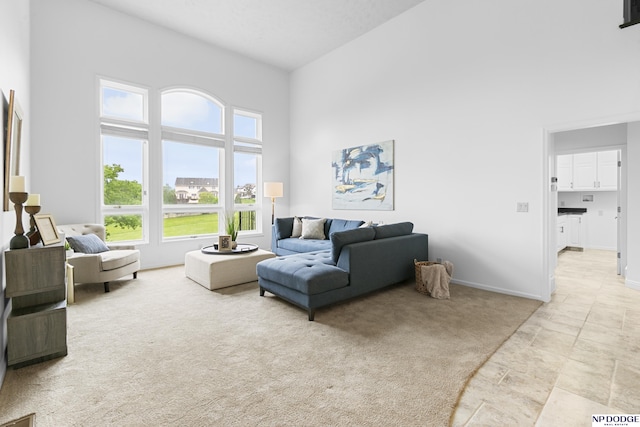910 W Centennial Rd, Papillion, NE 68046 - living area with a towering ceiling, light carpet, and baseboards