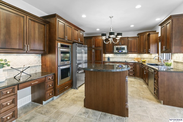 910 W Centennial Rd, Papillion, NE 68046 - kitchen featuring stainless steel appliances, a sink, a chandelier, dark stone counters, and a center island