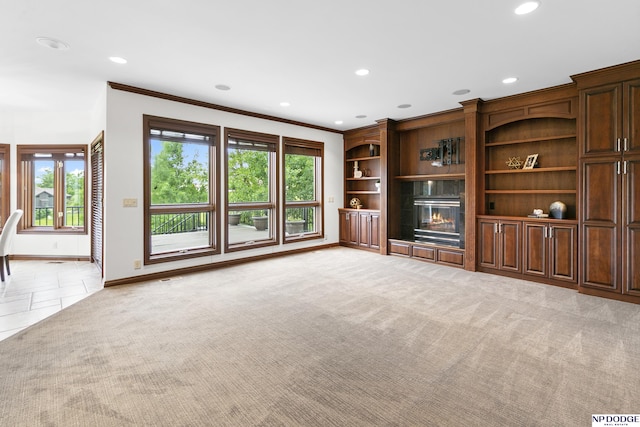 910 W Centennial Rd, Papillion, NE 68046 - unfurnished living room with recessed lighting, baseboards, crown molding, carpet flooring, and a glass covered fireplace