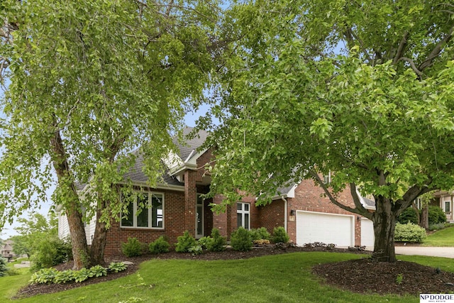 910 W Centennial Rd, Papillion, NE 68046 - obstructed view of property featuring a front lawn, brick siding, and concrete driveway