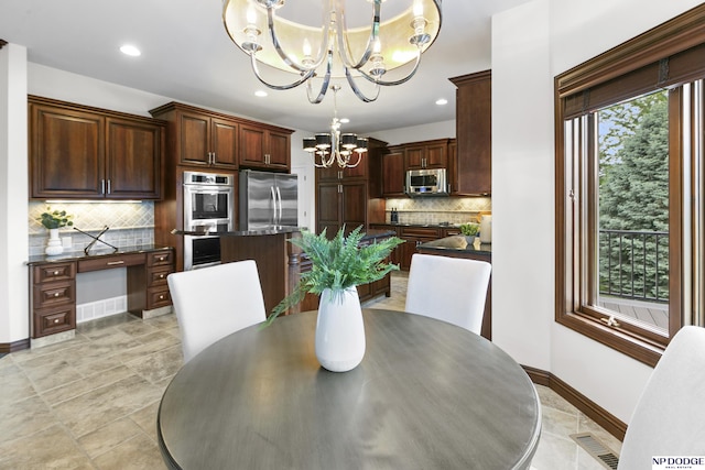 910 W Centennial Rd, Papillion, NE 68046 - dining area featuring a chandelier, baseboards, and recessed lighting