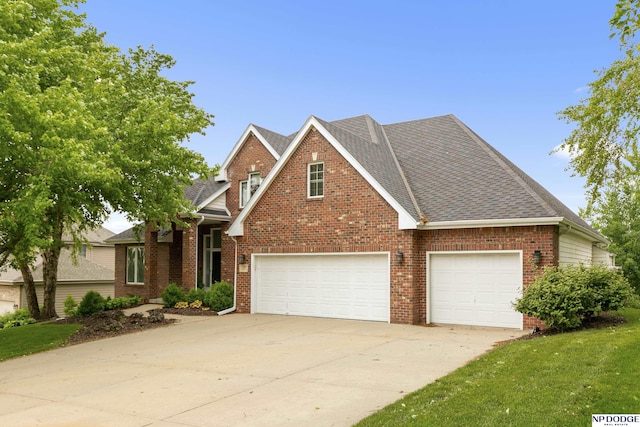 910 W Centennial Rd, Papillion, NE 68046 - traditional home with concrete driveway, brick siding, roof with shingles, a front yard, and a garage