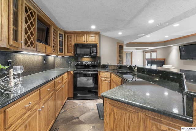 910 W Centennial Rd, Papillion, NE 68046 - kitchen featuring black appliances, a sink, brown cabinets, glass insert cabinets, and a peninsula