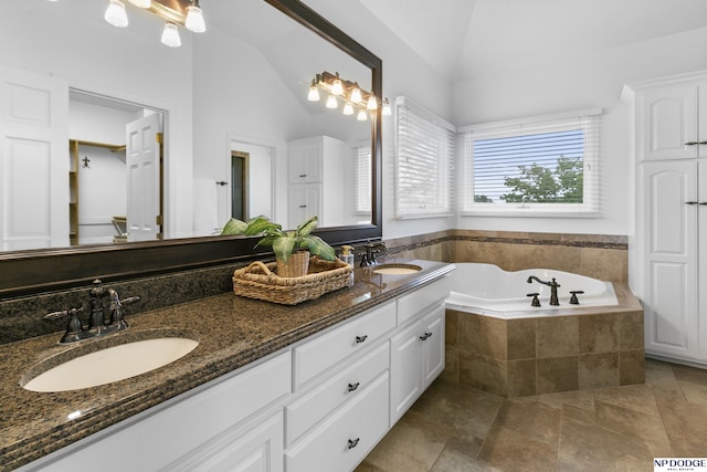 910 W Centennial Rd, Papillion, NE 68046 - bathroom with double vanity, a garden tub, high vaulted ceiling, and stone finish floors