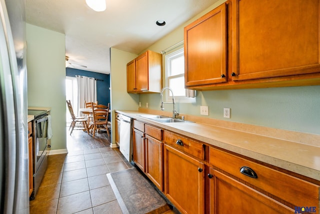 7348 N 19th St, Lincoln, NE 68521 - kitchen with a sink, stainless steel appliances, light countertops, and brown cabinets