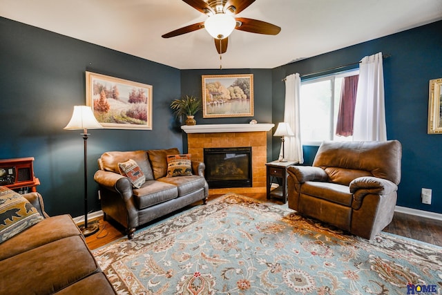 7348 N 19th St, Lincoln, NE 68521 - living room featuring baseboards, ceiling fan, wood finished floors, and a glass covered fireplace