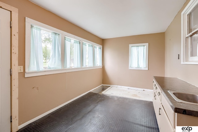 101 Station St, Shelby, IA 51570 - kitchen with plenty of natural light, dark countertops, baseboards, and a sink