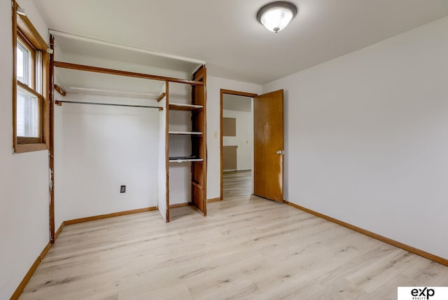 101 Station St, Shelby, IA 51570 - unfurnished bedroom with light wood-style flooring, baseboards, and a closet