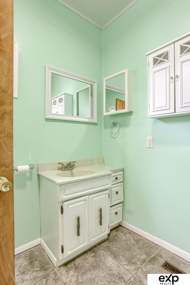 101 Station St, Shelby, IA 51570 - bathroom with vanity, crown molding, baseboards, and tile patterned floors