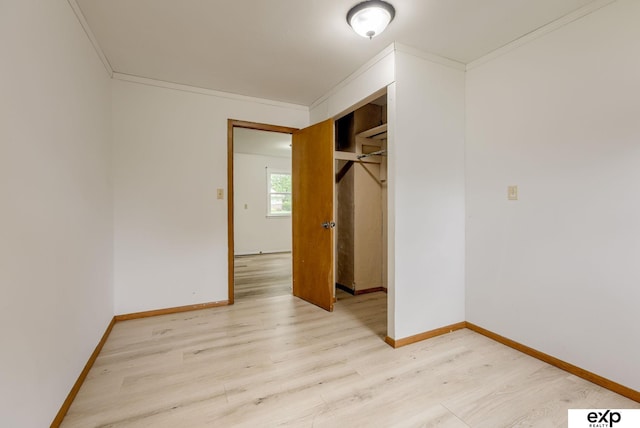101 Station St, Shelby, IA 51570 - unfurnished bedroom featuring light wood-style flooring, baseboards, crown molding, and a closet