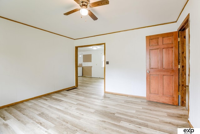 101 Station St, Shelby, IA 51570 - spare room with light wood finished floors, ornamental molding, ceiling fan, and baseboards