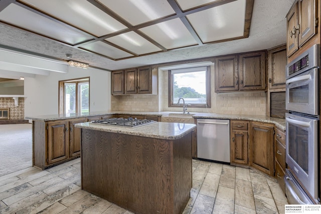 1905 S 116th St, Omaha, NE 68144 - kitchen with appliances with stainless steel finishes, a sink, healthy amount of natural light, and decorative backsplash