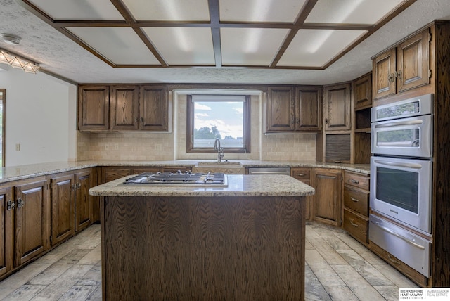 1905 S 116th St, Omaha, NE 68144 - kitchen featuring a warming drawer, stainless steel appliances, a sink, and backsplash