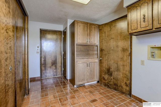 1905 S 116th St, Omaha, NE 68144 - laundry room featuring cabinet space, brick patterned floors, baseboards, and hookup for a washing machine