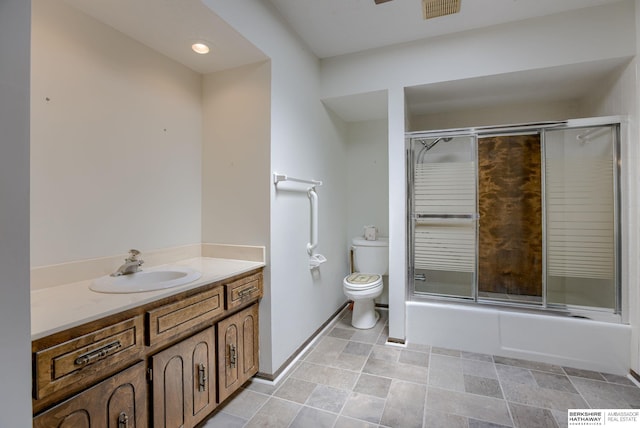 1905 S 116th St, Omaha, NE 68144 - bathroom featuring vanity, toilet, enclosed tub / shower combo, and baseboards