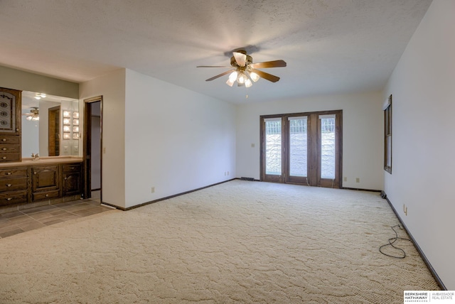 1905 S 116th St, Omaha, NE 68144 - spare room featuring light carpet, ceiling fan, baseboards, and a sink