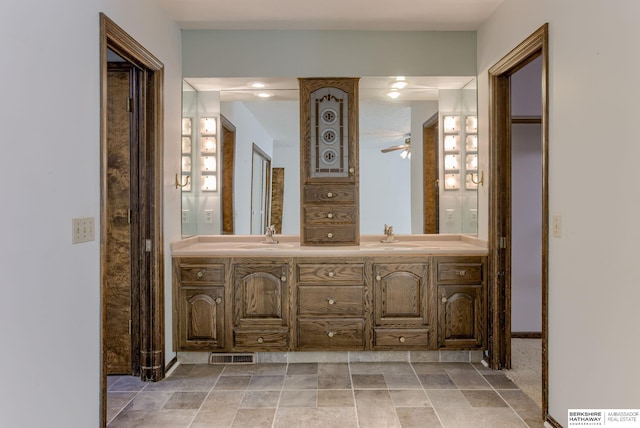 1905 S 116th St, Omaha, NE 68144 - bathroom with double vanity, a ceiling fan, and baseboards