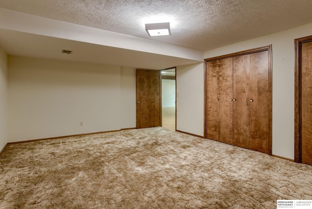 1905 S 116th St, Omaha, NE 68144 - unfurnished bedroom featuring two closets, carpet floors, a textured ceiling, and baseboards