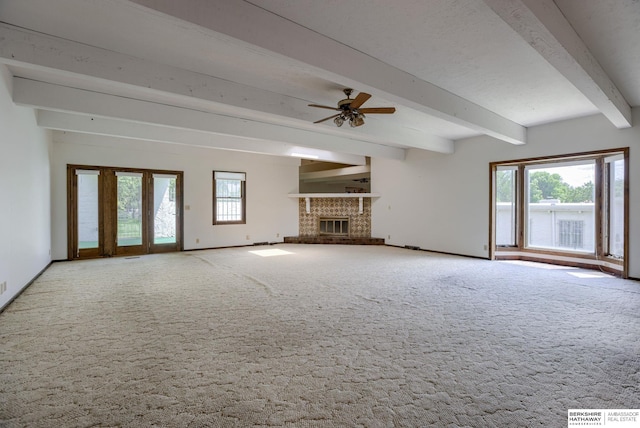 1905 S 116th St, Omaha, NE 68144 - unfurnished living room featuring beam ceiling, carpet, baseboards, ceiling fan, and a glass covered fireplace