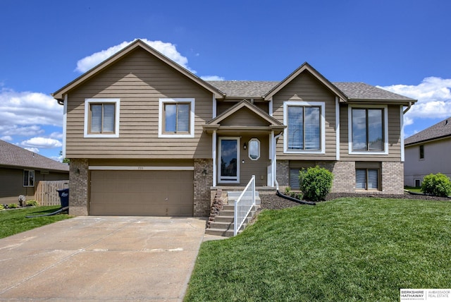705 Ruby Rd, Papillion, NE 68133 - raised ranch featuring brick siding, a garage, and a front lawn