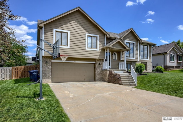 705 Ruby Rd, Papillion, NE 68133 - raised ranch featuring brick siding, an attached garage, and driveway
