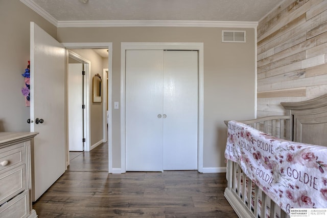 705 Ruby Rd, Papillion, NE 68133 - bedroom featuring ornamental molding, dark wood-style floors, a closet, wooden walls, and baseboards