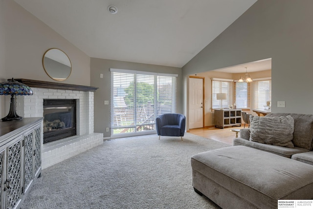 705 Ruby Rd, Papillion, NE 68133 - carpeted living area with a chandelier, plenty of natural light, a fireplace, and high vaulted ceiling