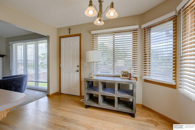 705 Ruby Rd, Papillion, NE 68133 - dining area featuring a chandelier, baseboards, and wood finished floors