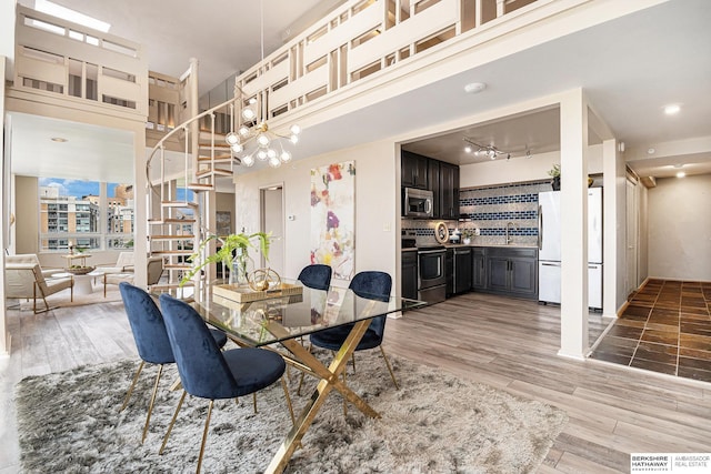 3000 Farnam St Unit 6H, Omaha, NE 68131 - dining space featuring stairway and light wood-style flooring