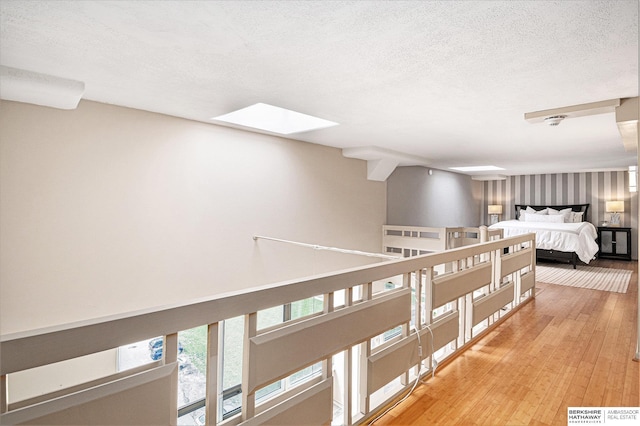 3000 Farnam St Unit 6H, Omaha, NE 68131 - corridor with light wood-style floors, a skylight, and a textured ceiling