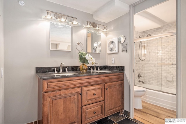 3000 Farnam St Unit 6H, Omaha, NE 68131 - full bathroom with toilet, double vanity, and bath / shower combo with glass door