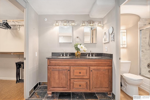 3000 Farnam St Unit 6H, Omaha, NE 68131 - full bathroom with double vanity, a shower, toilet, and a walk in closet
