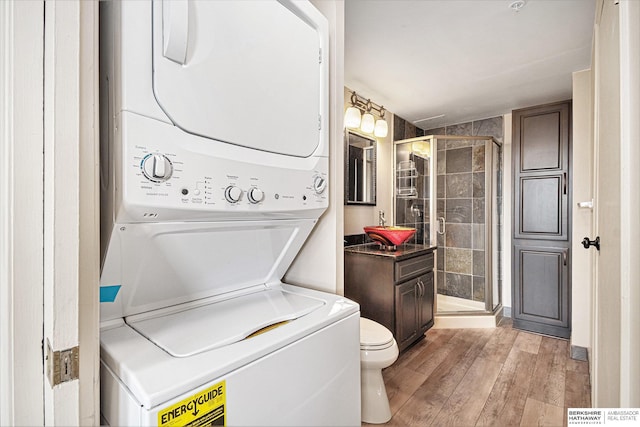 3000 Farnam St Unit 6H, Omaha, NE 68131 - laundry room featuring stacked washing machine and dryer and light wood finished floors