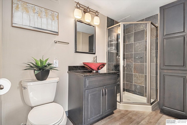 3000 Farnam St Unit 6H, Omaha, NE 68131 - full bath with toilet, a shower stall, vanity, and wood finished floors