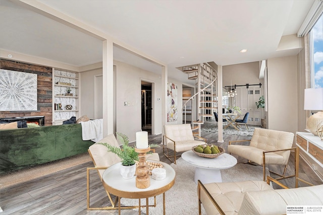 3000 Farnam St Unit 6H, Omaha, NE 68131 - living room with wood finished floors, stairs, a fireplace, and built in features