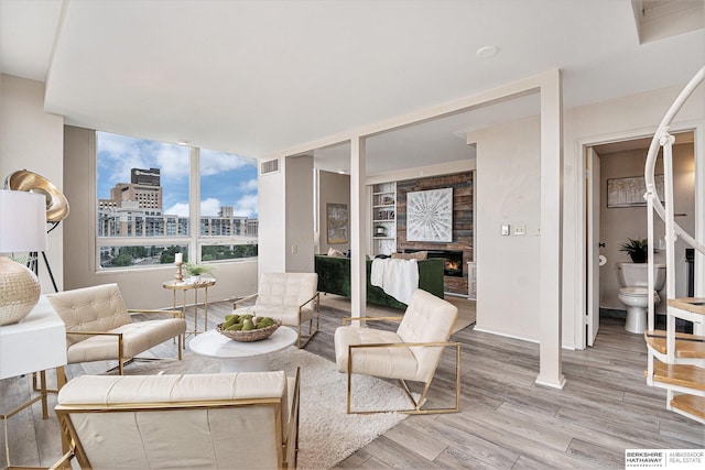 3000 Farnam St Unit 6H, Omaha, NE 68131 - living room with light wood-type flooring, a large fireplace, a city view, and built in features