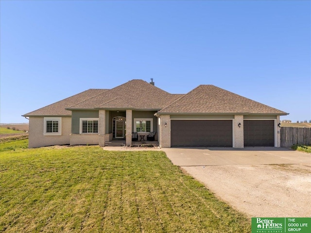 27896 Chestnut Rd, Treynor, IA 51575 - view of front of home featuring a garage, concrete driveway, brick siding, and a shingled roof